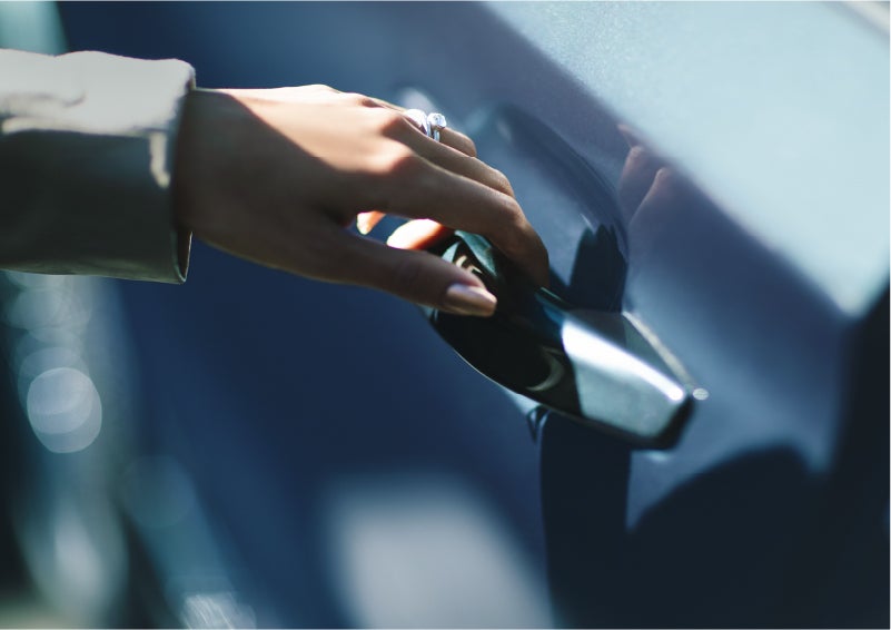 A hand gracefully grips the Light Touch Handle of a 2023 Lincoln Aviator® SUV to demonstrate its ease of use | Uptown Lincoln in Wauwatosa WI