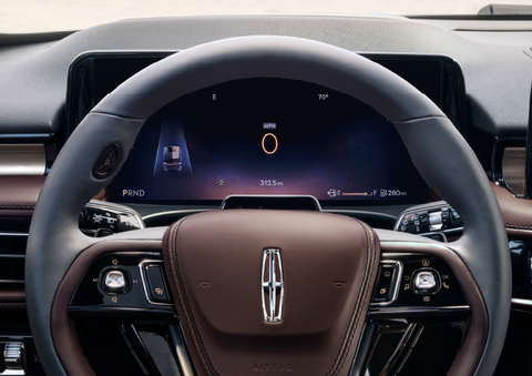 The steering wheel of 2025 Lincoln Aviator® SUV is shown with black and brown accents. | Uptown Lincoln in Wauwatosa WI