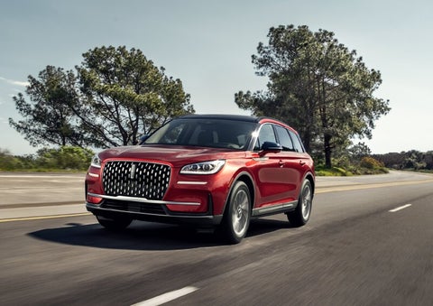 A 2025 Lincoln Corsair® SUV is shown being driven on a country road. | Uptown Lincoln in Wauwatosa WI
