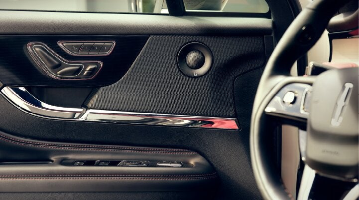 A Revel® audio speaker is shown in the driver's side door of a 2025 Lincoln Corsair® SUV. | Uptown Lincoln in Wauwatosa WI