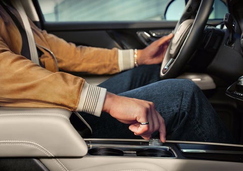 The driver of a 2024 Lincoln Corsair® SUV is shown selecting the drive mode. | Uptown Lincoln in Wauwatosa WI