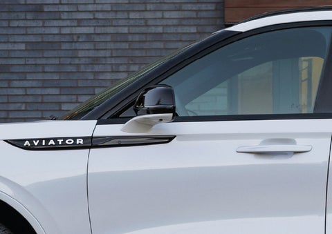 The driver’s side door and fender badging of a white 2026 Lincoln Aviator® SUV are showcased. | Uptown Lincoln in Wauwatosa WI
