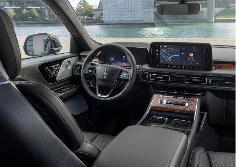 The interior of the 2026 Lincoln Aviator® SUV is shown parked with a view of a harbor through the windshield. | Uptown Lincoln in Wauwatosa WI