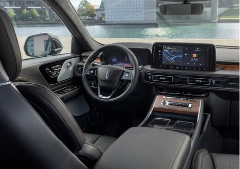 The interior of the 2026 Lincoln Aviator® SUV is shown parked with a view of a harbor through the windshield. | Uptown Lincoln in Wauwatosa WI