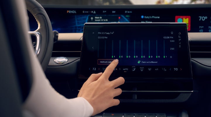 A woman is shown using the Auto Air Refresh feature in the 2026 Lincoln Nautilus® SUV. | Uptown Lincoln in Wauwatosa WI