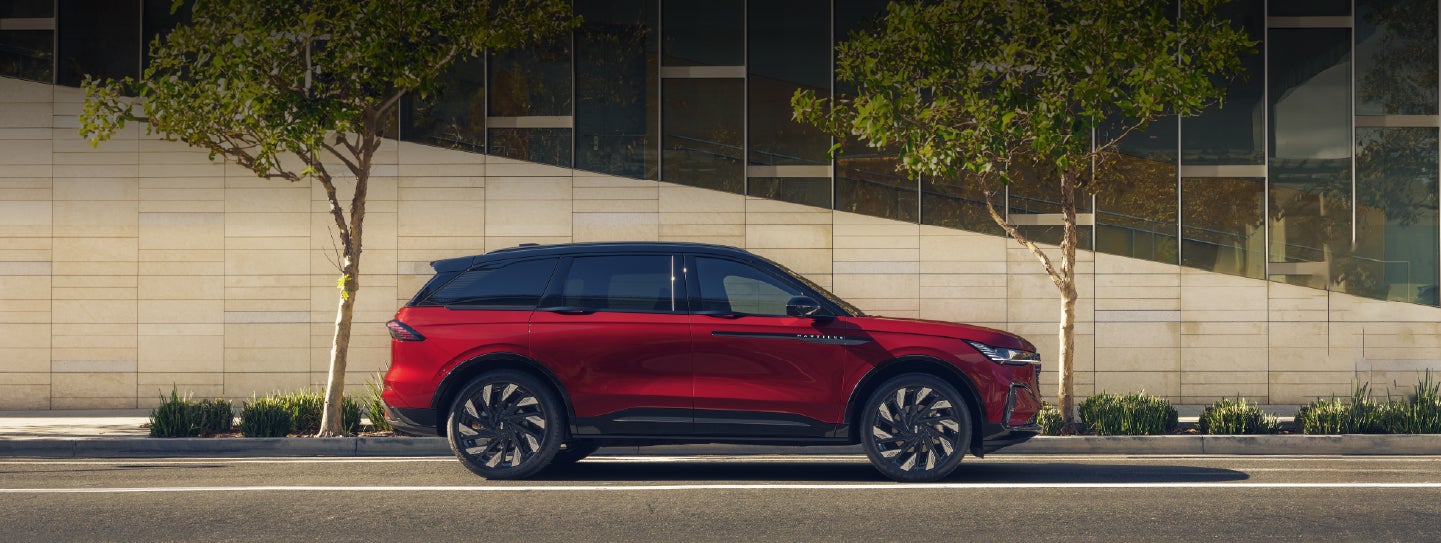 A 2026 Lincoln Nautilus® SUV with an available Hybrid Powertrain is parked in an urban setting. | Uptown Lincoln in Wauwatosa WI