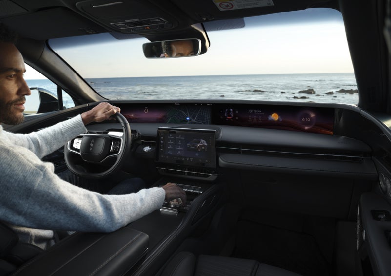 A driver of a parked 2026 Lincoln Nautilus® SUV takes a relaxing moment at a seaside overlook while inside his Nautilus. | Uptown Lincoln in Wauwatosa WI