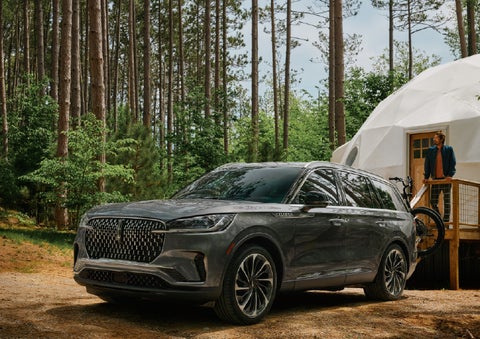 A 2027 Lincoln Aviator® is parked next to a high end glamping site. | Uptown Lincoln in Wauwatosa WI