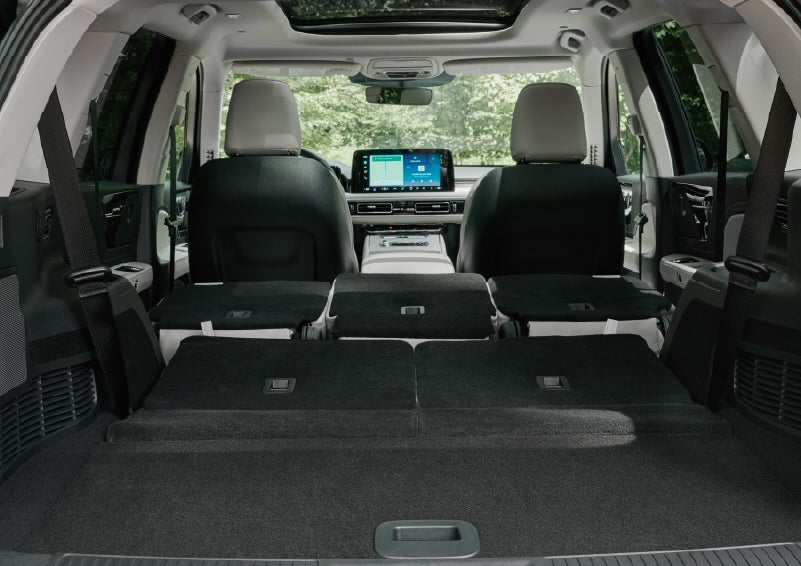 A rear to front view of the interior of a 2027 Lincoln Aviator® Black Label™ SUV shows the third and second rows folded flat | Uptown Lincoln in Wauwatosa WI