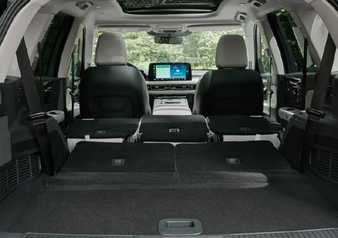 A rear to front view of the interior of a 2027 Lincoln Aviator® Black Label™ SUV shows the third and second rows folded flat | Uptown Lincoln in Wauwatosa WI