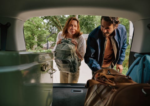 A couple loads luggage into the rear of a 2027 Lincoln Aviator® Black Label™ SUV..e 202 | Uptown Lincoln in Wauwatosa WI