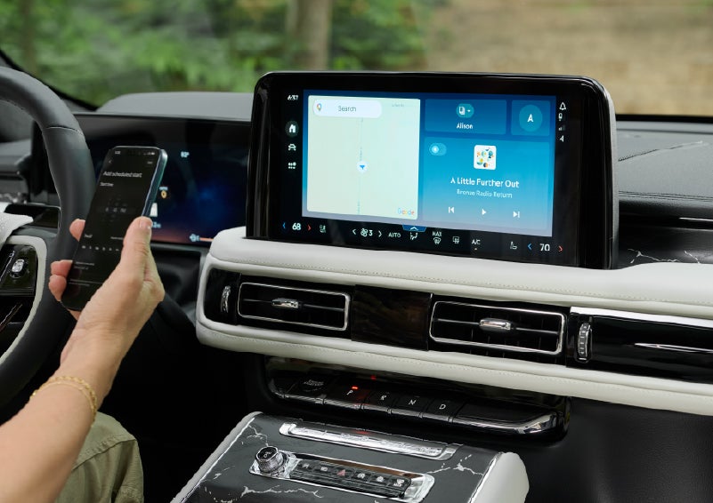 A person pairs thier phone with the center touchscreen of a 2027 Lincoln Aviator® Black Label™ SUV | Uptown Lincoln in Wauwatosa WI