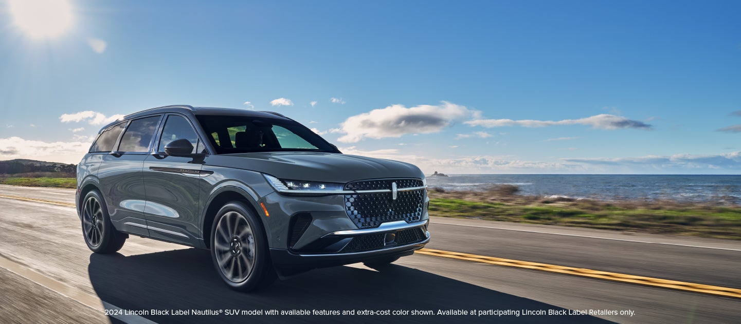 A 2024 Lincoln Nautilus® SUV is being driven on a coastal highway.