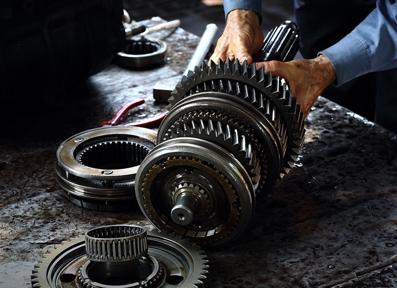 Close-up of a disassembled transmission gear assembly on a workshop bench
